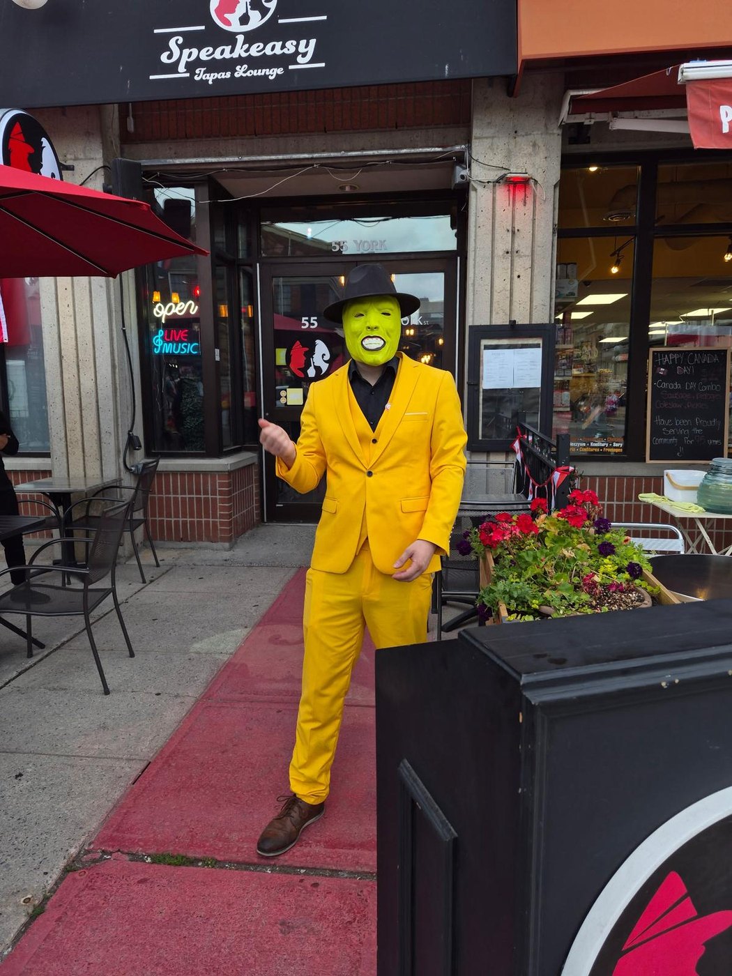 The Speakeasy doorman in a yellow suit and green mask outside 55 York Street